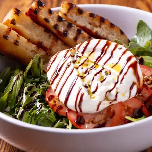 Burrata

Burrata cheese, tomatoes, baby arugula, balsamic drizzle, olive oil, and a house-made crostini.