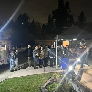 Condiment set up under an easy-up in the driveway