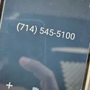 a hand holding a cell phone