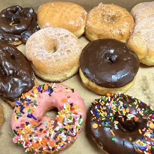 Various donuts (chocolate buttermilk, cake, jelly, sugar, etc.).