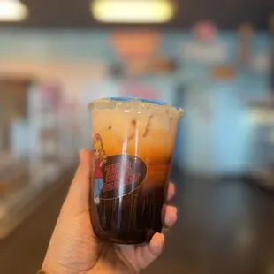 a hand holding a cup of coffee