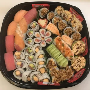 a tray of sushi and rolls