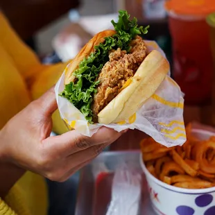 a person holding a sandwich