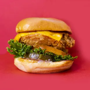 a hamburger with lettuce and cheese