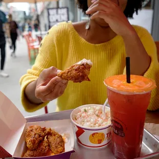 a woman eating a fried chicken