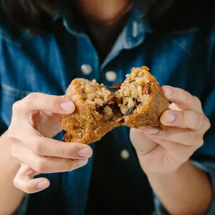 a woman holding a piece of food