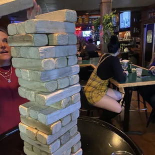 a woman stacking a block of pizza