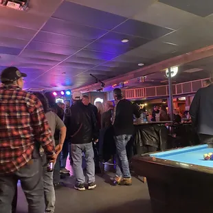 a group of people playing pool