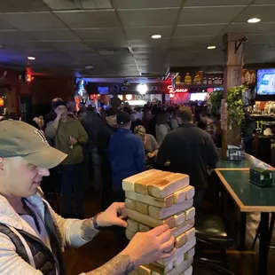 a man stacking up a stack of sandwiches