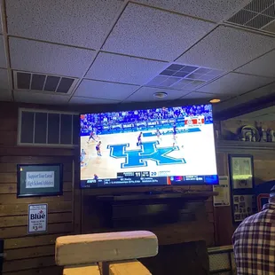 a man watching a basketball game on tv