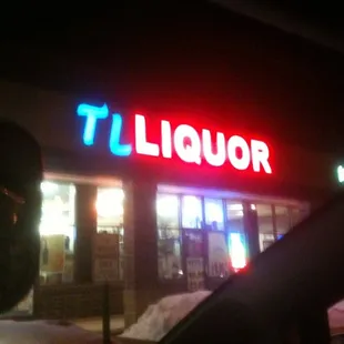 the front of a liquor shop at night