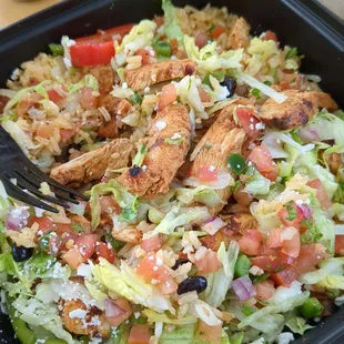 Chicken and rice bowl with pico de Gallo, fajita veggies, cotija cheese, And beans.