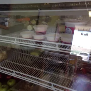 Some desserts in the glass case.