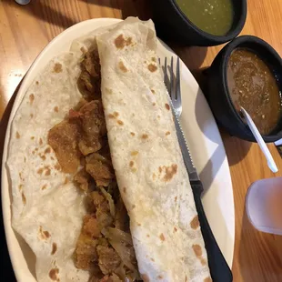 a tortilla with meat and sauces