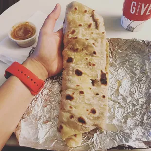 a person holding a tortilla