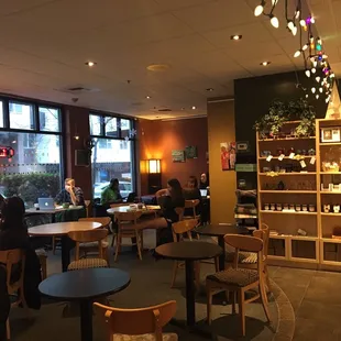 people sitting at tables in a coffee shop