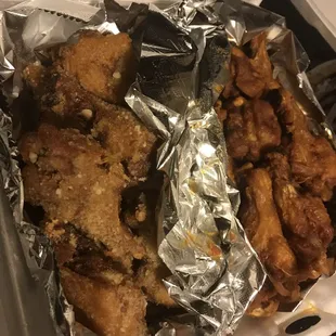 chicken wings and fries in a styrofoam container