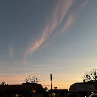 a street scene with a sunset in the background