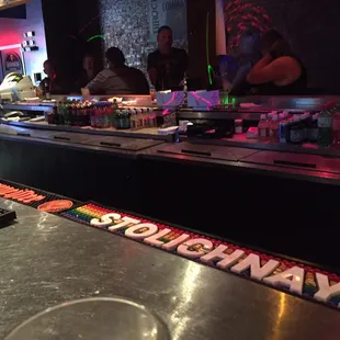 a sushi bar with sushi rolls on the counter