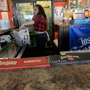 One of the day bartenders restocking
