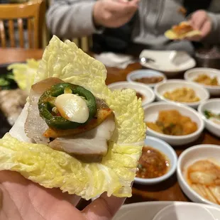 a person holding a piece of food