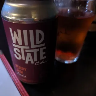 a glass of beer and a can of wild state