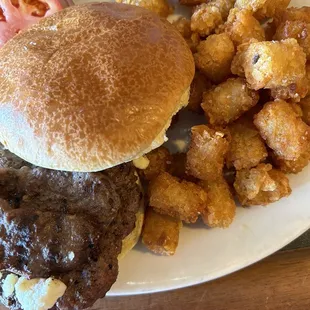Trojan Burger. Oh so good juicy burger with gyro meat, feta &amp; tzatziki sauce with crispy tots. If you're hungry, this is the perfect combo.