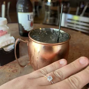 a woman's hand holding a cocktail