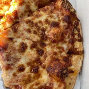 Looks to be cooked but the cheese is not melted on