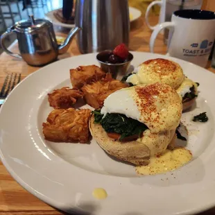 Florentine Benedict w/ hash brown squares, fruit medley and fresh brewed coffee.