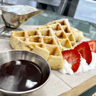 waffles with strawberries and syrup