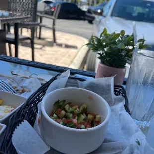 a bowl of salad and a glass of water