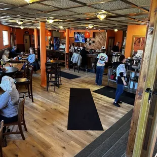 people sitting at tables in a restaurant