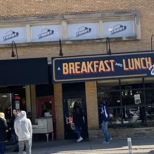 Front door showing people waiting outside for a table