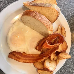 2 Side of Two-Eggs, bacon, Home Fries, and sourdough.