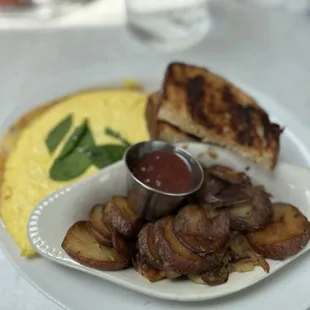 Crawfish omelette and side of potatoes