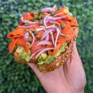 Santa Barbara Toast - piled high with smoked salmon, avocado, fresh dill, capers, and red onions.