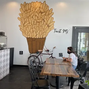 a woman sitting at a table in a coffee shop