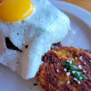 a fried egg and a hash browns on a plate