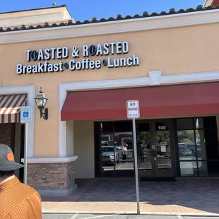 The sign out front of the building and entrance