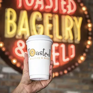 a hand holding a cup