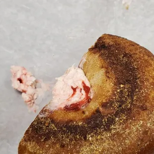 Strawberry cream cheese on a cinnamon raisin