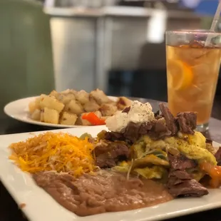 a plate of mexican food and a drink