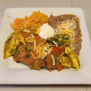 Chilaquiles in a spicy salsa verde. Tasty but super soggy chips.