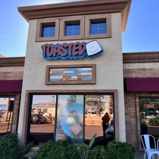 a woman sitting outside a restaurant