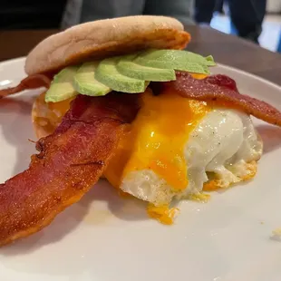 Breakfast Sandwich with Bacon, Egg, Cheese, and Avocado on an English Muffin