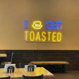 a neon sign that reads i get toasted