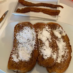 a plate of french toast and bacon