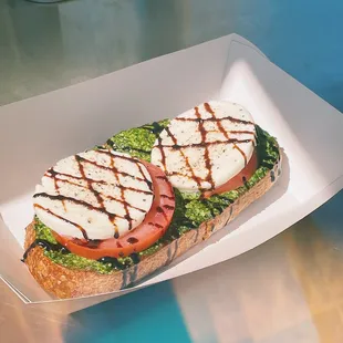 a sandwich with tomatoes and mozzarella