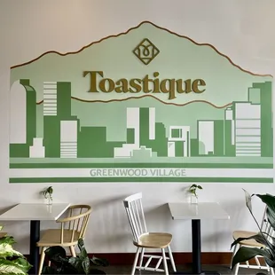 Dining area with store name decal on wall